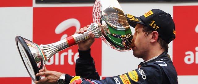 Sebastian Vettel celebrates victory in India with a healthy swig of champagne - Photo Credit: Mark Thompson/Getty Images