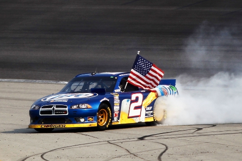 Victory at Chicagoland started Keselowski towards the title, with his now familiar flag-in-hand burnout (Photo Credit: Todd Warshaw/Getty Images for NASCAR)