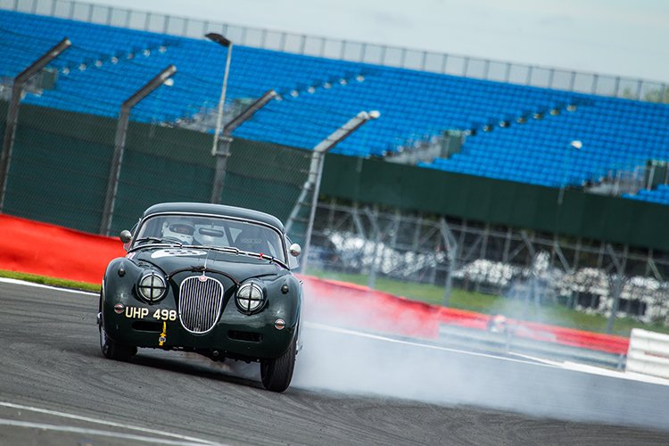 A classic Jaguar on the limit at the 2016 Silverstone Classic.