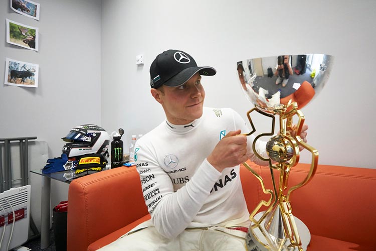Bottas inspects his winning trophy - Credit: Daimler AG