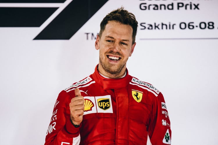 Sebastian Vettel celebrating victory on the podium at the 2018 Bahrain Grand Prix