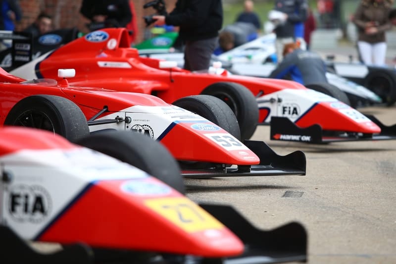 British F4 cars in the pit-lane.