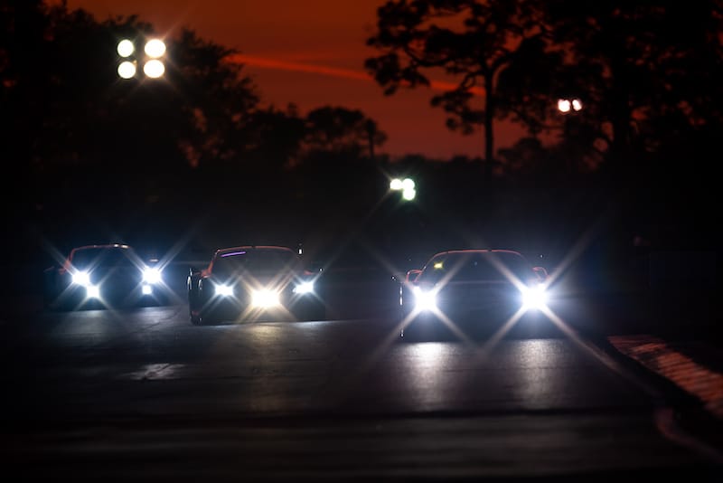 GT racers at night